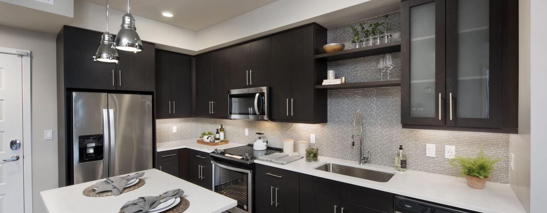 a kitchen with black cabinets