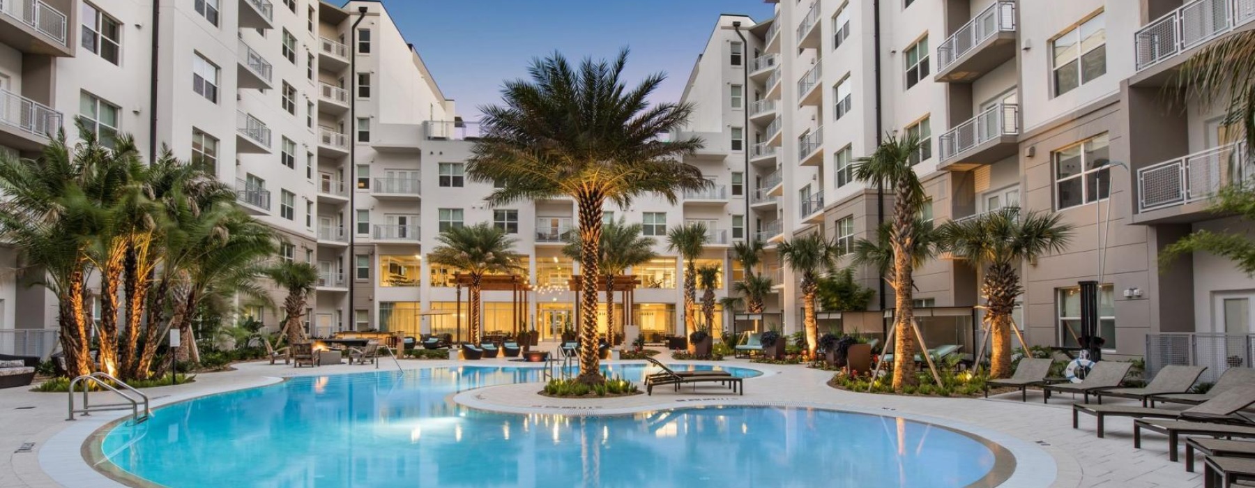 a pool in a courtyard between buildings